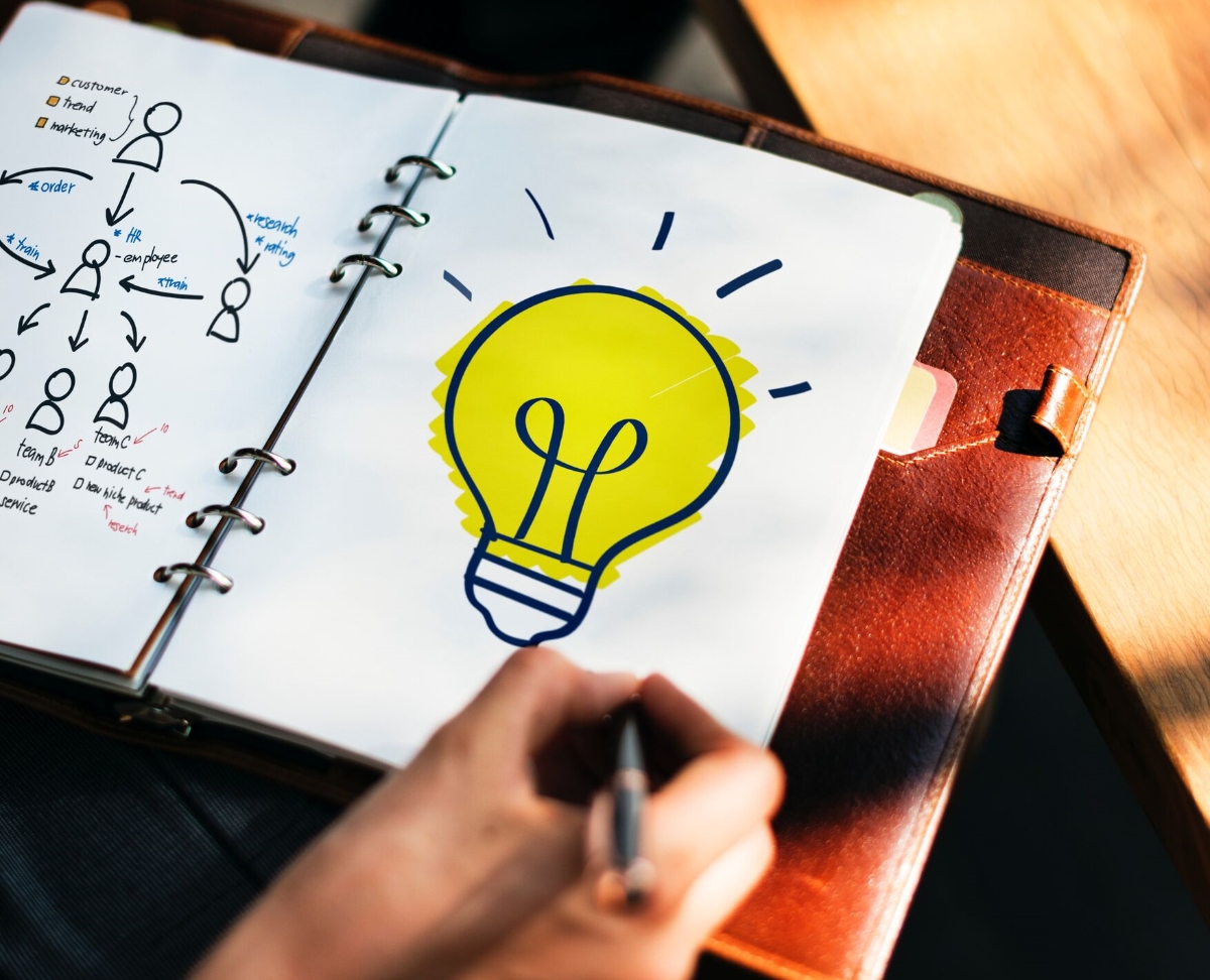 A hand drawn lightbulb in a notebook